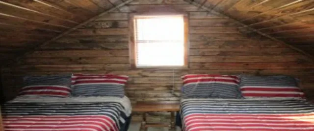 Cabin 10 upstairs bedroom with two full beds