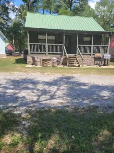 Cabin 3 from outside, with its green metal roof and porch