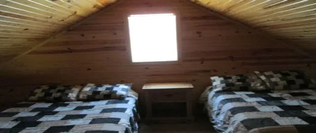 Cabin 8 upstairs bedroom with a queen and a full bed