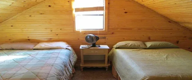 Cabin 9 upstairs bedroom with a queen and a full bed