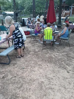 Guests gathered under the oaks on the lawn