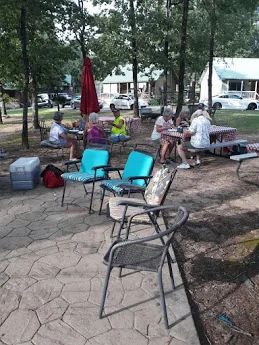 Guests on the concrete patio under an umbrella