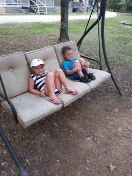 Two children on the porch swing